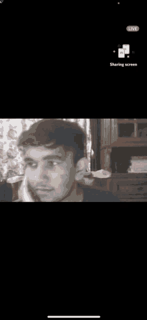 a phone screen shows a man talking on a cell phone with a live sharing screen icon