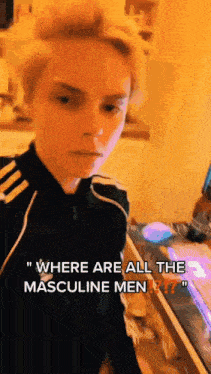 a young man is standing in front of a counter and talking about where are all the masculine men ?