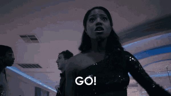 a woman in a black dress says go