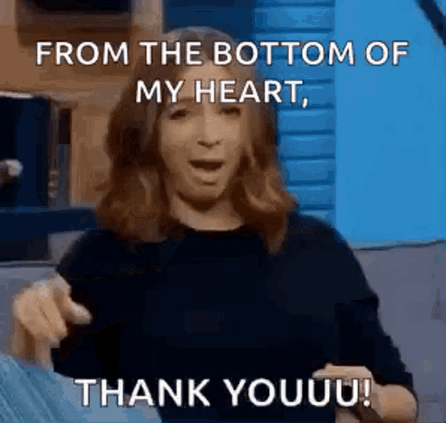 a woman is sitting on a couch and saying `` from the bottom of my heart , thank youuu ! ''