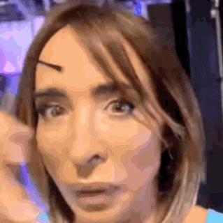 a close up of a woman 's face with a slight smirk on her face .