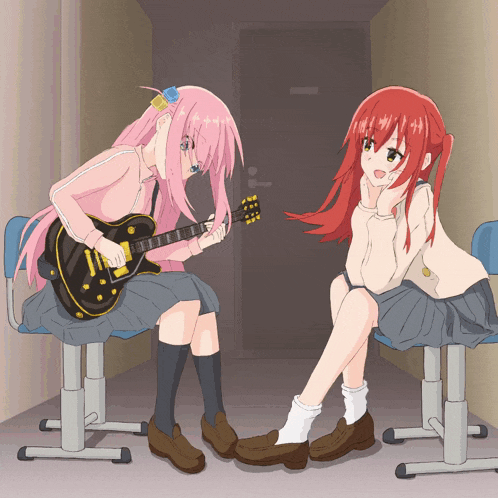a girl playing a guitar next to another girl