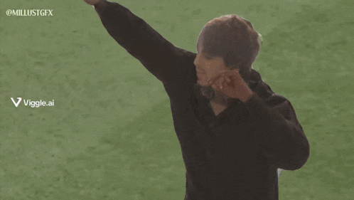 a man stands on a soccer field with his arms outstretched in front of an espn live advertisement