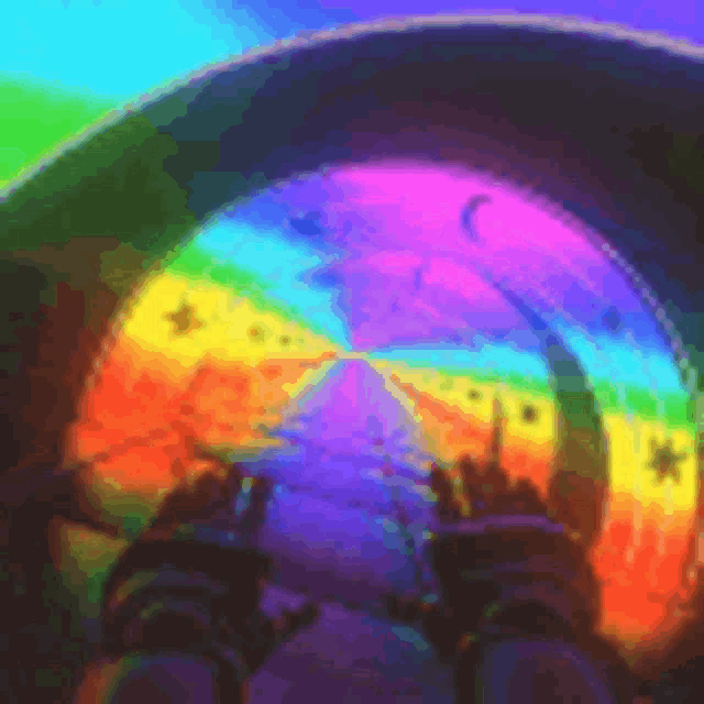 a person is holding a rainbow colored object in front of a rainbow tunnel .