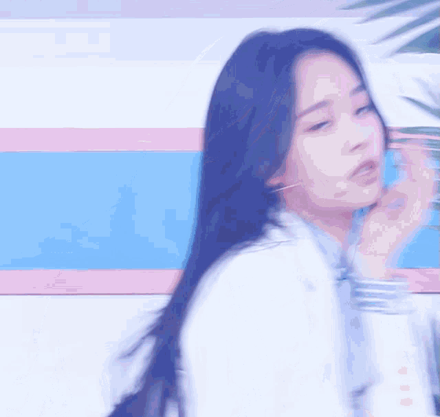a blurry picture of a woman in a white jacket