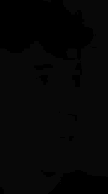 a black and white photo of a young man 's face with his mouth open
