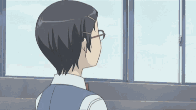 a girl with glasses looks out a window