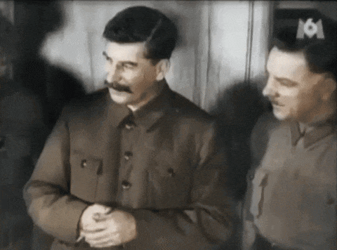 a man with a mustache is standing next to another man with the number 16 on their hat