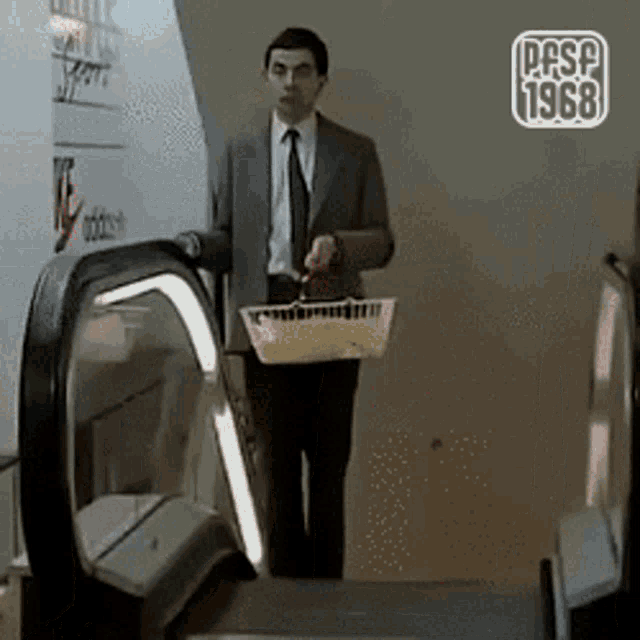 a man in a suit and tie is holding a basket in front of an escalator that says ppsp 1968 on it