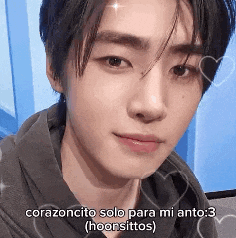 a close up of a young man 's face with hearts around it and a caption .