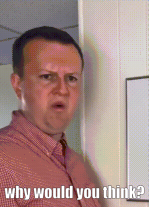 a man in a red shirt is standing in front of a white board and asking why would you think ?