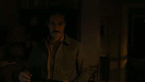 a man with a mustache says well like i said in a dark room