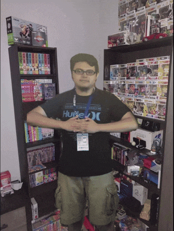 a man wearing a hurley t-shirt stands in front of a bookshelf