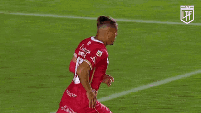a soccer player in a red jersey with the number 15 on it