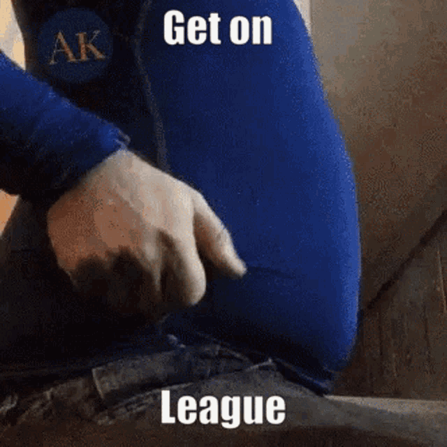 a person is sitting down with their hands on their stomach and the words get on league written on the bottom .