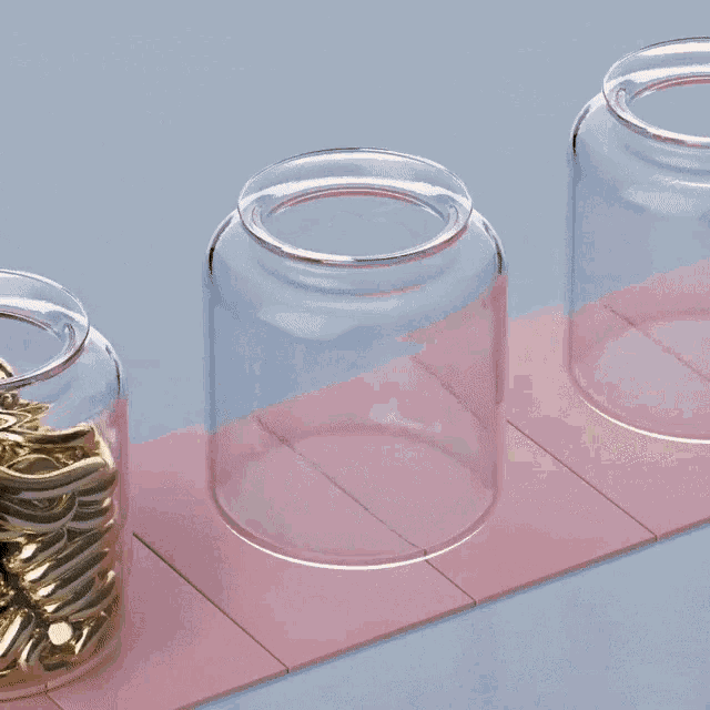 three jars filled with gold noodles on a pink table