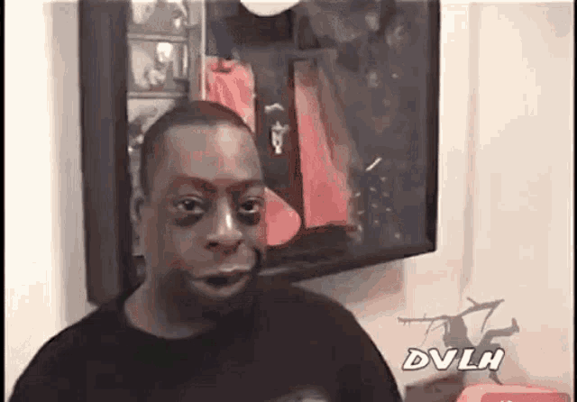 a man in a black shirt with dvlh on the bottom right