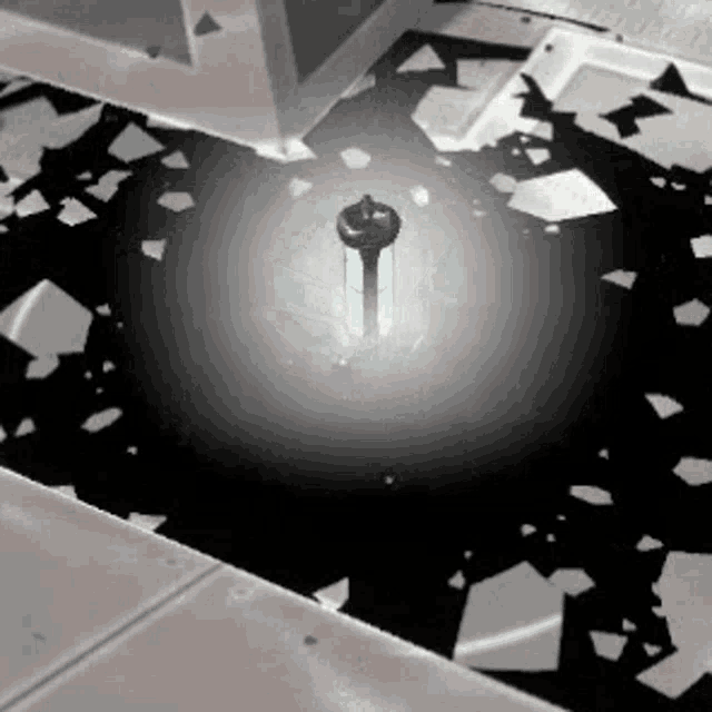a glowing object is in the middle of a room with a lot of broken glass