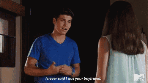 a man in a blue shirt is talking to a woman in a light blue dress .