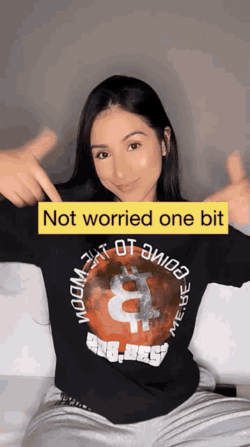 a woman is wearing a black shirt that says not worried one bit