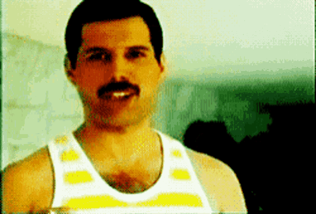 a man with a mustache wearing a white and yellow tank top