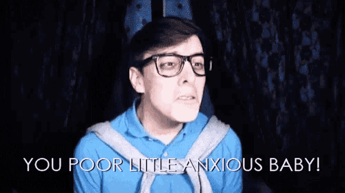 a man wearing glasses and a blue shirt says you poor little anxious baby .