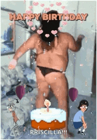 a naked man is dancing in front of a birthday cake with candles .
