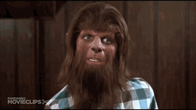 a man in a plaid shirt has a beard and looks like a werewolf from the movie teen wolf
