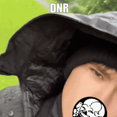a man wearing a hooded jacket has the word dnr written on his face