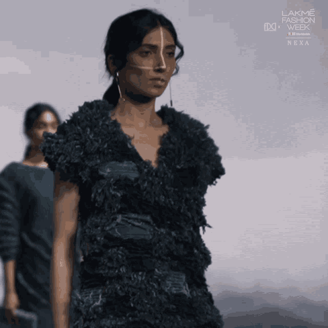 a model walks down the runway at lakme fashion week next