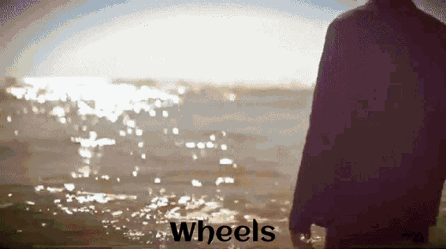 a person standing in the water with the words wheels written below them