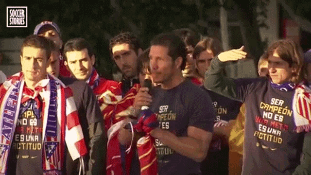 a group of men wearing shirts that say ser campeon no es buena actitud