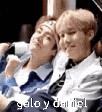 two men are sitting next to each other on a couch with the words galo y daniel written on the bottom .