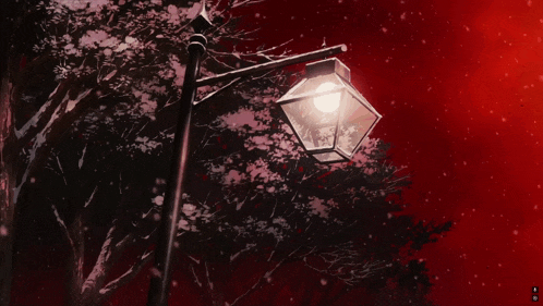 a lamp post with a light on it in front of a tree with a red background