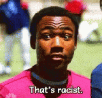 a man is wearing a pink shirt that says that 's racist
