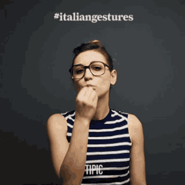 a woman wearing glasses and a striped shirt with tipic on it