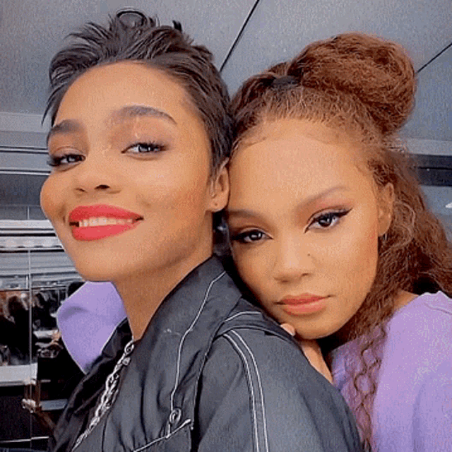 two women are posing for a picture and one has red lipstick