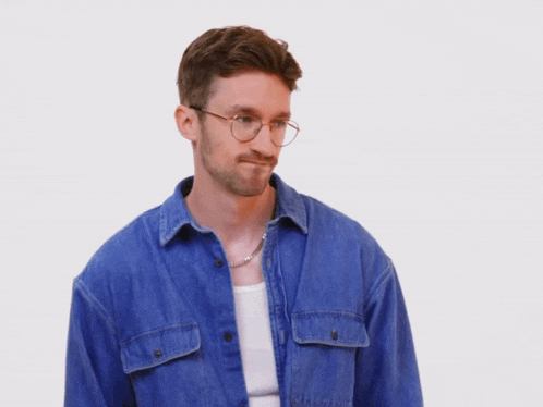 a man wearing glasses and a denim shirt