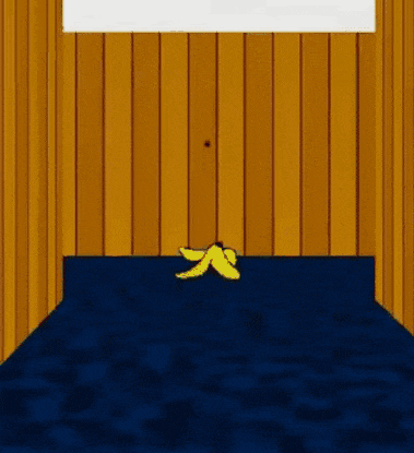 a banana peel is on the floor in a room with wood paneling