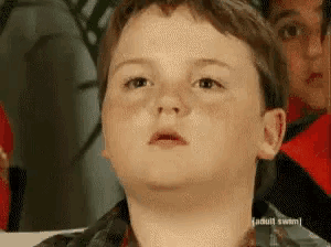 a close up of a young boy 's face with the words adult swim on the bottom right