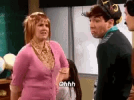 a man and a woman are standing next to each other in a room .