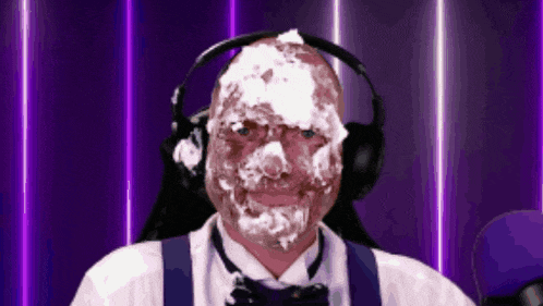 a man with foam on his face is wearing headphones and a bow tie