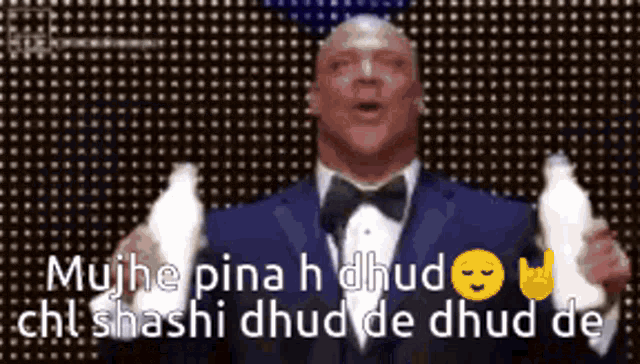 a man in a tuxedo is holding a bottle of milk and says mujhe pina h dhud