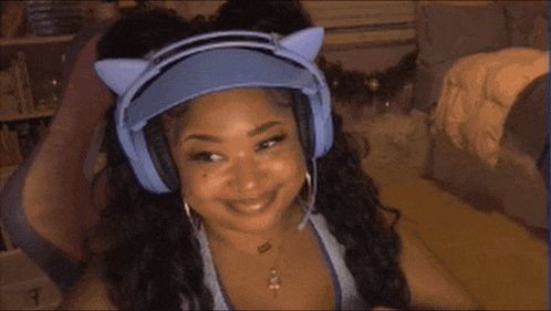 a woman wearing headphones and a visor with cat ears