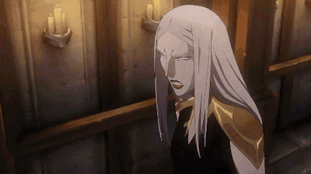 a woman with long white hair stands in front of a wall with candles