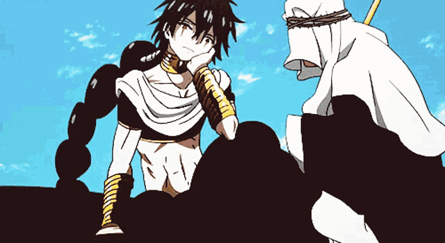 a man in a white robe sits next to another man in a white robe