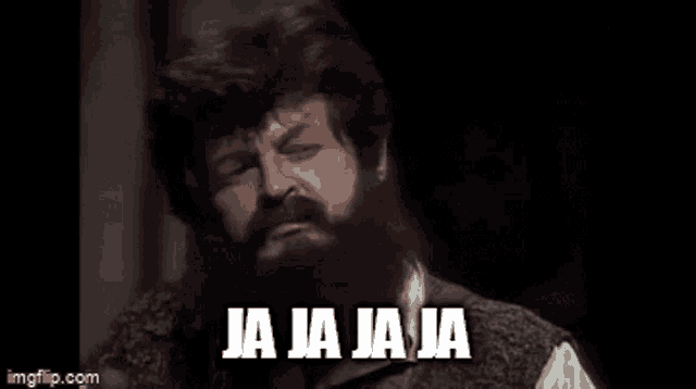 a man with a beard is making a funny face and saying ja ja ja ja in spanish .