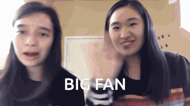 two girls are standing next to each other with the words big fan written on their faces