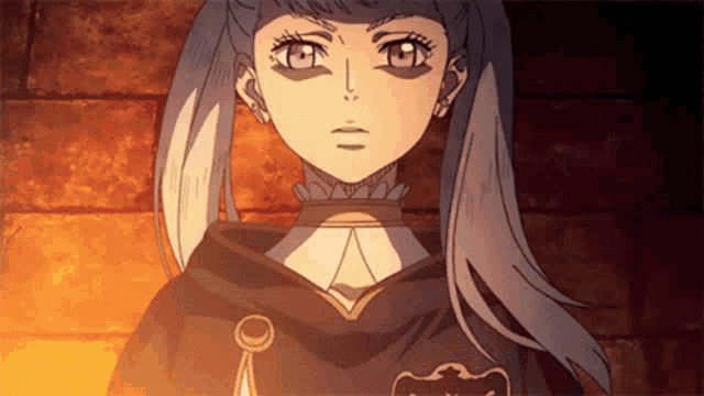 a close up of a girl 's face with a black cape