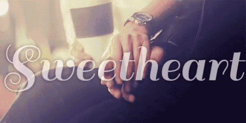 a person holding another person 's hand with the word sweetheart in the background